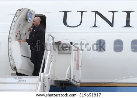 MILAN MALPENSA - JUNE 16, 2015: A functionary of american government opens the hold door of the presidential aircraft (Air Force Two) few moments before the exit of Michelle Obama.