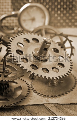 mechanical clock gears on the old wooden table
