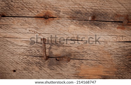 Old rusty nail on the old wooden table