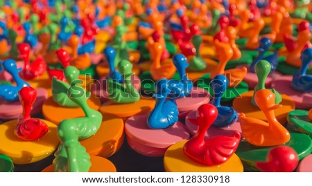Various color plastic ducks floating on the water