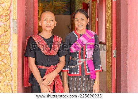 NAKORN PHANOM THAILAND, OCTOBER 18: Young tour guides in traditional dresses at That Prasith temple on Oct 18, 2014 in Nakorn Phanom, Thailand. Nakorn Phanom is a northeastern province of Thailand