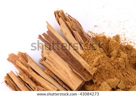 Cinnamon and cinnamon powder on white background