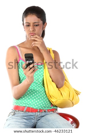 Young student woman with notebook sending sms with cell phone over a white background