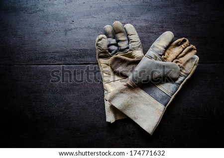 old leather gloves on wooden table
