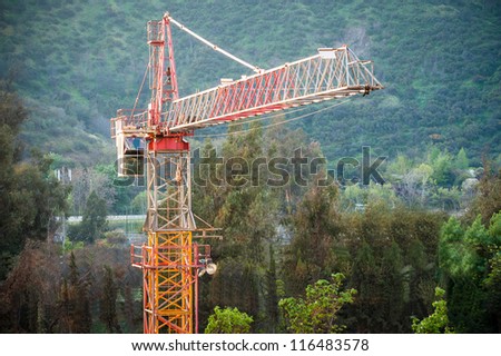Construction industry type of picture, showing a big crane in the middle of the city