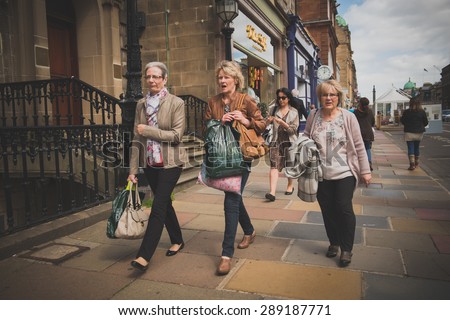 EDINBURGH, SCOTLAND / UNITED KINGDOM - MAY 24 2015 - Three Unidentified mature women of Edinburgh, walking through the royal mile in old town.