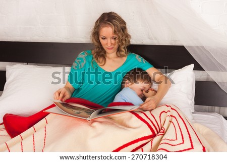 Mother reading book to sleep her little child