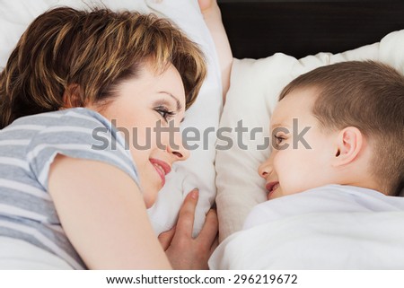 Happy woman looking at her son and smiling