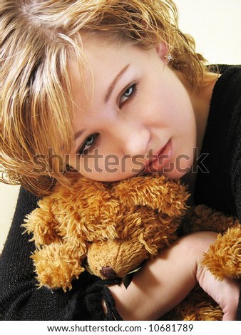 Young beautiful woman hold her lovely teddy bear