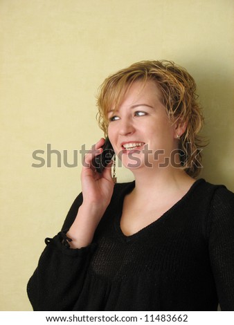 Young beautiful girl talking on cellphone and laughing