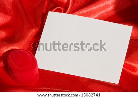 Red jewerly  box and empty card on red satin