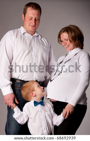happy family with cute boy expecting another baby
