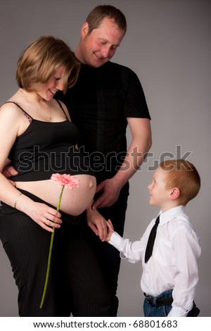 happy family with cute boy expecting another baby