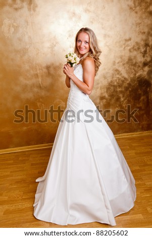 Beautiful blonde haired woman in white bridal dress