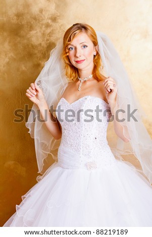 Beautiful red haired woman in white bridal dress