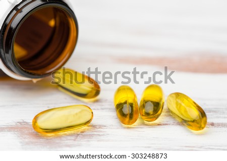 vitamin capsules with E poured out of bottle