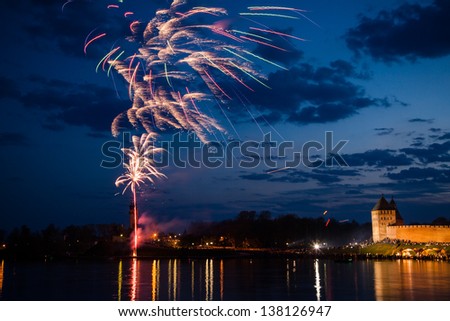 Colorful firework in a night sky, reflection in water