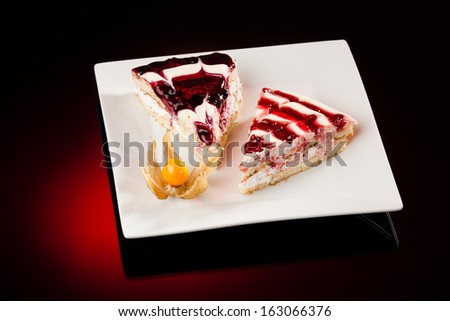 Two piece of cheesecake on a black background
