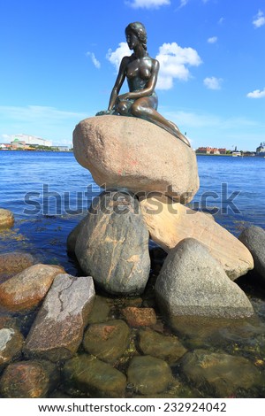COPENHAGEN - JUNE 30: The Little Mermaid, a bronze statue by Edvard Eriksen, depicting a mermaid. The sculpture is displayed by the waterside at the Langelinie promenade in Copenhagen, Denmark