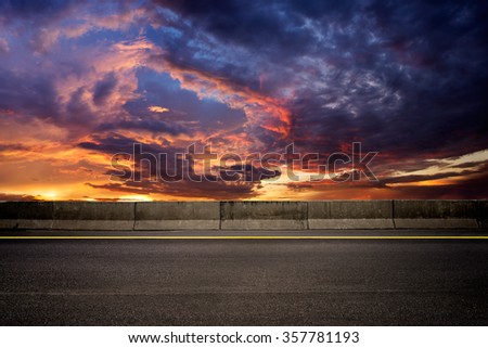 Dark road on sunset setting