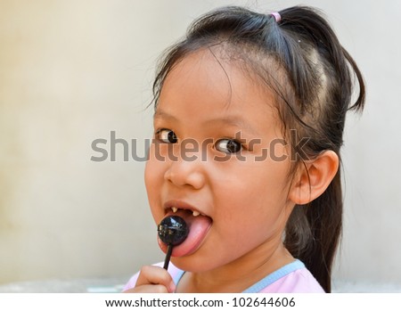 broken teeth girl and lollypop of thailand southeast asia