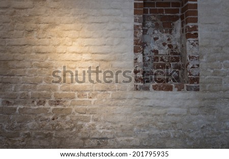 Light patch of light on the old plastered brick wall as background