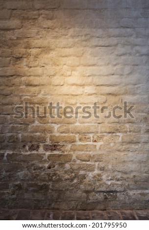 Light patch of light on the old plastered brick wall as background