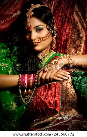 Indian woman laying in luxury ethnic interior.