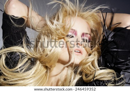 Dancing blond girl with hair in wind.
