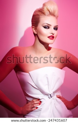 Female model posing in pink light.