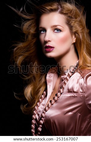 Model wearing pink silk blouse.
