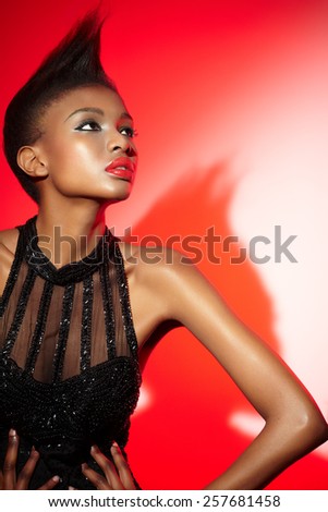 African fashion model wearing vintage sequin dress.