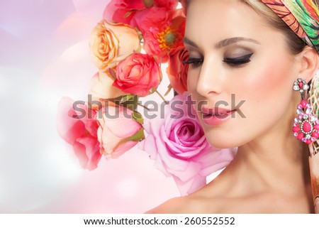 Beautiful spring woman with flowers. Glowing colorful summer fashion concept.