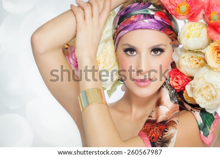 Beautiful spring woman with flowers. Glowing colorful summer fashion concept.