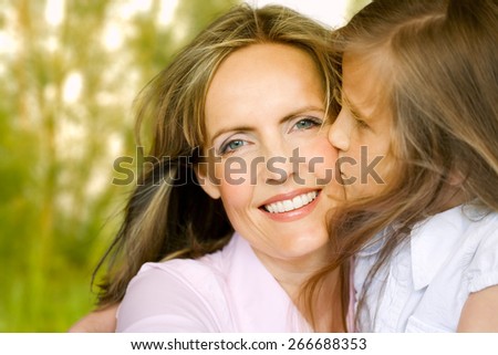 Daughter kissing her mom.