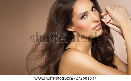 Portrait of beautiful woman with long brunette fashion hair style. Elegant Latina model with long dark hair.