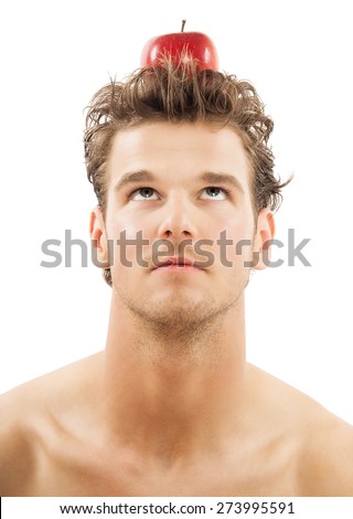 Young Caucasian man with red apple on top of head over white background. Eureka ideas and healthy eating concept.