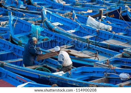 ESSAOUIRA, MOROCCO - MARCH 2: Unidentified fisherman preparing their boat for traditional art fishing in the fishing harbour of Essaouira, on March 2, 2012 in Essaouira, Morocco.