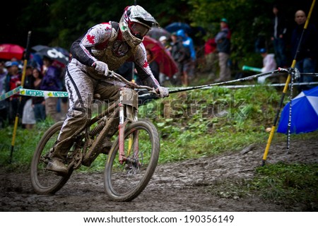 CHAMPERY, SWITZERLAND - SEPTEMBER 21: An unidentified rider completing his final run during the final of the champery UCI downhill world championships 2011.