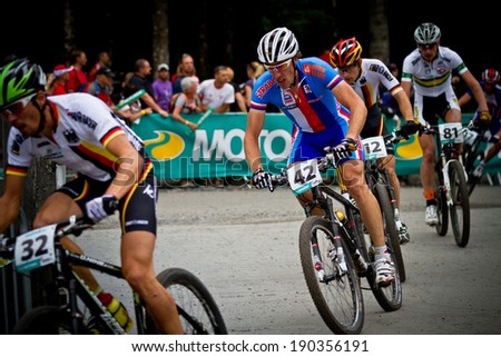 CHAMPERY, SWITZERLAND, SEPTEMBER 21: A group of unidentified bikers as they compete at the UCI downhill world championships 2011.