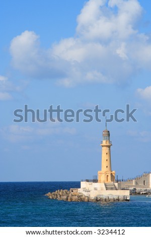 A lighthouse with large sky area and some clouds. This lighthouse is in Alexandria, Egypt
