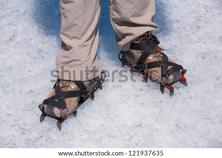 Legs of a man in boots cats. Glacier Perito Moreno, National Park Los Glasyares, Patagonia, Argentina