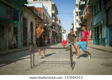 HAVANA, CUBA - JUNE 23: Unidentified young men playing soccer in the streets of Havana. Havana, Cuba, June 23, 2013. Sport is very popular in Cuba, a lot of people practicing sports in the street.
