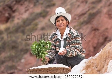 MARAS, PERU - SEPTEMBER 10: The unknown woman in traditional clothes on salty mines Maras, Peru, 10 Septiember 2014. Salt from Maras is well-known for the whole world for the quality