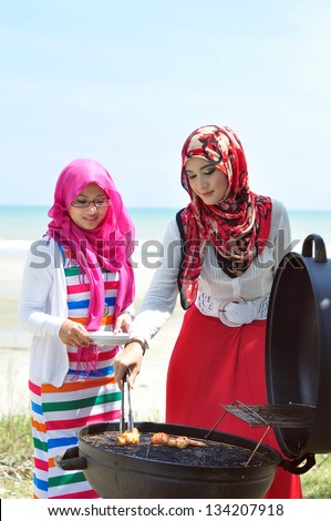 Young muslim women enjoying barbecue