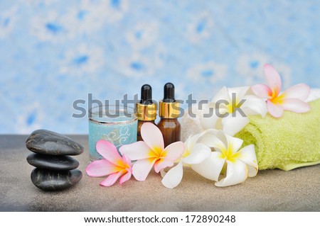 white and pink frangipani flower with zen stones essential oil and towel, Spa concept