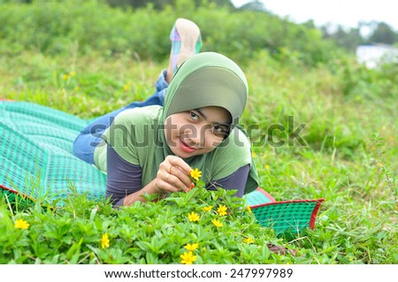 Young muslim woman in head scarf smile at park