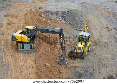 works in an industrial zone in construction witch excavator machines
