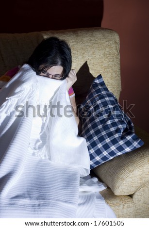 woman watching a scary and horror movie in the tv in a room