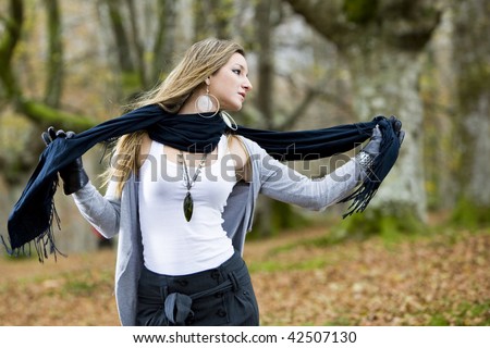 beautiful young fashion woman posing in an autumn forest